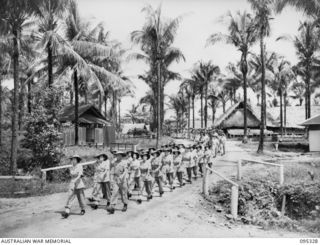 PALMALMAL PLANTATION, JACQUINOT BAY, NEW BRITAIN, 1945-08-19. MEMBERS OF THE AUSTRALIAN ARMY MEDICAL WOMEN'S SERVICE IN A MARCH THROUGH GROUNDS OF 2/8 GENERAL HOSPITAL TO A THANKSGIVING SERVICE ..