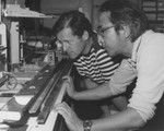 Scientist Seiya Uyeda, right, of the Earthquake Research Institute, Tokyo, and Co-Chief Scientist on Leg 60 of Deep Sea Drilling Project with colleague and oceanographer Timothy J.G. Francis, of the Institute of Oceanographic Sciences, Blacknest, Brimpton, Reading, England. They are conducting thermal conductivity measurements of a core recovered north of Guam near the Mariana Trench. The equipment they are using measures the dissipation of heat in the core material. 1978