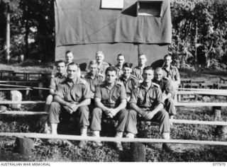OFFICERS ON THE STAFF OF HEADQUARTERS, 23RD INFANTRY BRIGADE SEATED ON THE BENCHES IN THE UNIT MOVIE THEATRE. IDENTIFIED PERSONNEL ARE:- 30121 LIEUTENANT R.E. JONES (1); VX100371 LIEUTENANT A.W.F. ..