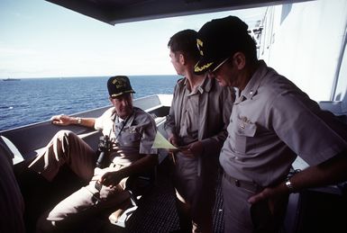 CAPT J. W. Renard, commanding officer, seated, discusses plans with his executive officer and the watch officer aboard the amphibious assault ship USS SAIPAN (LHA-2) during exercise Ocean Venture '81