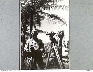 FINSCHHAFEN AREA, NEW GUINEA. 1943-11-09. SURVEYORS OF THE 870TH UNITED STATES ENGINEER AVIATION BATTALION SURVEYING THE LEVELS FOR A NEW ROAD BETWEEN DREGER HARBOUR AND THE NEW AIRSTRIP. SHOWN ..