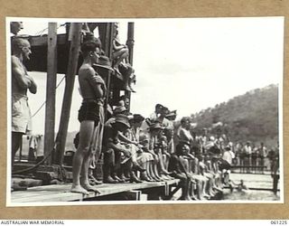 PORT MORESBY, NEW GUINEA. 1943-11-28. A HANDY GRANDSTAND. THE HIGH DIVING TOWER CONVERTED FROM A PILE DRIVER IS USED BY THIS CROWD TO OBTAIN A BETTER VIEW OF THE EVENTS