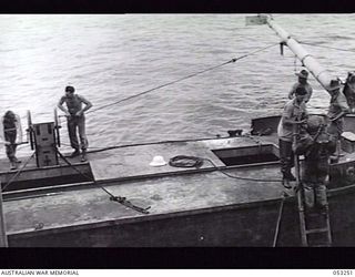 MILNE BAY, NEW GUINEA. 1943-06-29. DIVER READY TO DESCEND INTO THE WATER DURING SALVAGE OPERATIONS BY THE 2/3RD AUSTRALIAN DOCKS OPERATING COMPANY, ROYAL AUSTRALIAN ENGINEERS ON THE "ANSHUN", SUNK ..