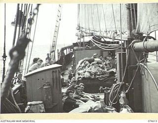 AT SEA. 1944-07-12. AUSTRALIAN TROOPS RELAXING ON THE DECK OF THE AK 95 A 300 TON KETCH OF THE 12TH SMALL SHIPS COMPANY WHILE SAILING THE BISMARCK SEA ON THEIR WAY TO MADANG