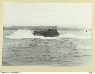 ALEXISHAFEN, NEW GUINEA. 1944-08-03. AN LCM (LANDING CRAFT MECHANISED) RUNNING INTO HEAVY WEATHER AS IT APPROACHES THE BAY ENTRANCE