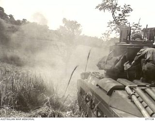 GUSIKA, NEW GUINEA. 1944-03-15. A MATILDA TANK FROM THE 1ST TANK BATTALION, FIRING A 3" HOWITZER HIGH EXPLOSIVE 119 TO TEST THE VULNERIBILITY OF A CUPOLA FITTED TO THE BODY OF ANOTHER MATILDA TANK. ..