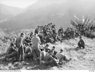 YAULA, NEW GUINEA. 1944-04-08. VX104114 CHAPLAIN G.T. SAMBELL (1), CONDUCTING THE EASTER SUNDAY SERVICE ON A MOUNTAIN TOP OVERLOOKING BOGADJIM WITH MEMBERS OF C COMPANY HEADQUARTERS, 57/60TH ..