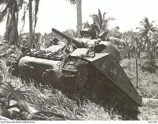 MADANG, NEW GUINEA. 1944-10. 'THE STAG', A SHERMAN M4A2 MEDIUM TANK APPROACHING THE TOP OF COURSE NO. 2 DURING TANK TESTS AT HQ 4 ARMOURED BRIGADE