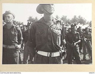 AITAPE, NEW GUINEA. 1945-04-17. LIEUTENANT COLONEL E.C. HENNESSY, COMMANDING OFFICER 2/6 CAVALRY (COMMANDO) REGIMENT (1), ON PARADE LISTENING TO AN ADDRESS BY MAJOR GENERAL J.E.S. STEVENS, GENERAL ..