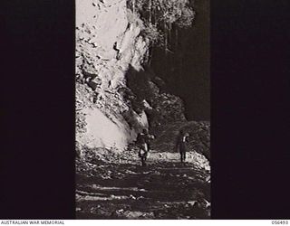 REINHOLD HIGHWAY, NEW GUINEA, 1943-08-31. LARGE ROCK FACE AT CENTRE CAMP