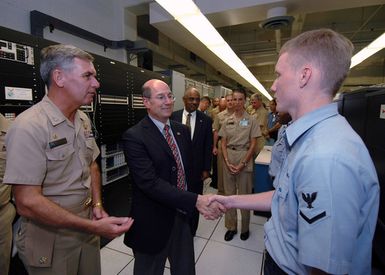 The Honorable Dr. Donald C. Winter, center, Secretary of the Navy (SECNAV), greets U.S. Navy Information Systems Technician 3rd Class Brent Jackson duirng his visit at Naval Computer and Telecommunications Area MASTER Station, Pacific (NCTAMSPAC), Hawaii, on Aug. 22, 2006. The SECNAV is currently visiting military installations and commands in the Hawaii Region. NCTAMSPAC manages, operates and maintains Defense Communication System and Naval Telecommunication System assets by offering a full range of automated data processing and information resource services. (U.S. Navy photo by Mass Communication SPECIALIST 1ST Class James E. Foehl) (Released)