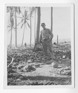 [Serviceman Standing Among Debris on Guadalcanal]