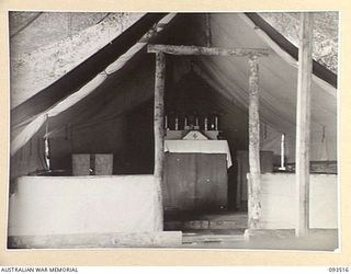 TOKO, BOUGAINVILLE. 1945-06-30. THE INTERIOR OF THE ROMAN CATHOLIC CHAPEL AT HEADQUARTERS 3 DIVISION. IT WAS PHOTOGRAPHED AT THE REQUEST OF CHAPLAIN F.H. GALLAGHER, ROMAN CATHOLIC CHAPLAIN, ..