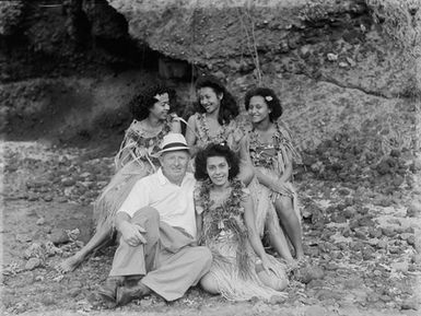 [Group portrait of Tudor Collins and four women in a coastal setting]