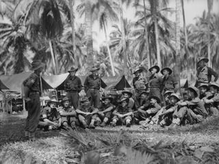 MADANG, NEW GUINEA. 1944-06-17. SIGNALS PERSONNEL OF HEADQUARTERS COMPANY, 58/59TH INFANTRY BATTALION, LISTENING TO A LECTURE BEING DELIVERED BY VX102577 SERGEANT (SGT) F. J. CRAIG (1) (FAR LEFT). ..