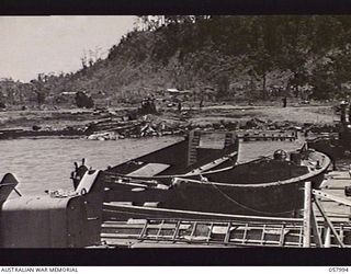 LAE, NEW GUINEA. 1943-10-12. TWO BARGES MOORED WITH THE PD.240, THE 50 TON FLOATING CRANE OPERATED BY THE UNITED STATES SMALL SHIPS SECTION. THE ONE ON THE LEFT IS A JAPANESE BARGE WHICH WAS ..