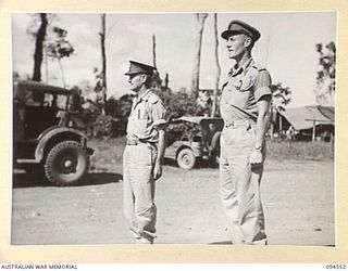 LAE AREA, NEW GUINEA, 1945-08-05. BRIGADIER P.S. MCGRATH, DEPUTY DIRECTOR OF SUPPLIES AND TRANSPORT (1) AND MAJOR C.F. MULCAHY, COMMANDING OFFICER 151 GENERAL TRANSPORT COMPANY (2), DURING A PARADE ..