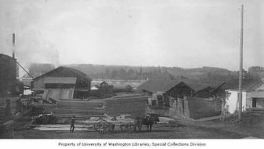 Capital Lumber Company lumber yard showing men loading a horse drawn wagon, Salem, Oregon, between 1895 and 1905