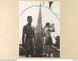 MADANG, NEW GUINEA. 1944-11-06. LIEUTENANT EDWARDS, (2), TAKING OBSERVATIONS FROM THE BRIDGE OF HMAS STAWELL