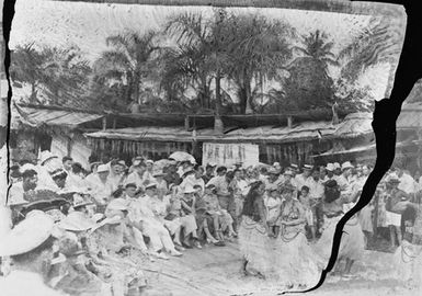 [A crowd watching a Pacific Island performance]