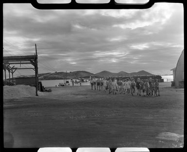 School group walking on the wharf, La Flotille, Noumea, New Caledonia, a Qantas Catalina flying boat in the background