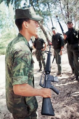 SSGT Richard Bishop, a Marine Corps instructor, explains an attack maneuver to a group of Air Force security policemen undergoing anti-terrorist training