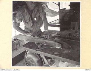 MOEM, WEWAK AREA, NEW GUINEA, 1945-09-17. SERGEANT J. CROWE, 2/4 ARMOURED REGIMENT DETACHMENT WITH 4 INFANTRY TROOPS WORKSHOP, WORKING IN THE CARPENTER'S SHOP WHICH IS MOUNTED ON A TRUCK