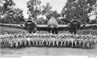 Ward's Airfield, Papua. 1943-06. Group portrait of air crew of No. 30 Squadron RAAF in front of one of the Squadron's Beaufighter aircraft. The navigators are standing behind the pilots. Left to ..