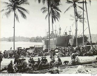 LANGEMAK BAY, NEW GUINEA. 1944-04-23. TROOPS OF THE 5TH DIVISION WAITING TO BOARD AN AMERICAN LIBERTY SHIP FOR THE JOURNEY TO SAIDOR