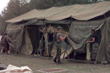 US Air Force Airmen, assigned to the 36th Civil Engineer Squadron, Andersen Air Force base, Guam, are setting up tents to house Airmen from the 96th Bomb Squadron and support personnel from the 2nd Bomb Wing, Barksdale Air Force Base, Louisiana. The Airmen are deployed to Naval Station Diego Garcia in support of Operation DESERT THUNDER 2