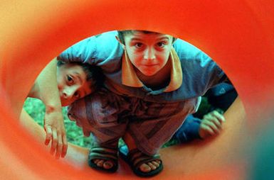 Kurdish children play at a playground near the family housing complex used as their temporary lodging at Andersen Air Force Base, Guam, during Operation PACIFIC HAVEN. The operation, a joint humanitarian effort conducted by the US military, entails the evacuation of over 2,400 Kurds from northern Iraq to avoid retaliation from Iraq for working with the US government and international humanitarian agencies. The Kurds will be housed at Andersen AFB, while they go through the immigration process for residence in the United States