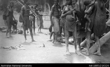 Village scene with multiple individuals including women and children