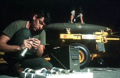 Airmen prepare 500-lb. Mark 82 bombs for loading on an F-4 Phantom II aircraft. The airmen are from the 3rd Munitions Maintenance Squadron, involved in exercise Opportune Journey 4