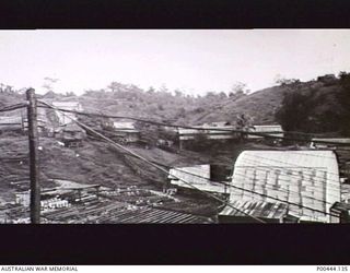 ADMIRALTY ISLANDS 1947-07. PICTURE THEATRE AT THE LORENGAU NAVAL STORES DEPOT. ON THE LEFT CAN BE SEEN THE PROJECTION ROOM AND COVERED ENCLOSURE FOR OFFICERS. (NAVAL HISTORICAL COLLECTION)