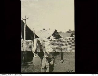 TADJI NEAR AITAPE, NORTH EAST NEW GUINEA. C. 1944-10. 430933 SERGEANT N. R. MAXWELL, KEW, VIC, WIRELESS AIR GUNNER, OF NO. 100 (BEAUFORT) SQUADRON RAAF, SMASHES ONE BALL OVER THE NET PLAYING ..