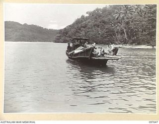 FAURO ISLAND, BOUGAINVILLE AREA. 1945-10-01. JAPANESE BARGE CARRYING SIGN "CONTAGIOUS PATIENTS" WAITS OFF THE BEACH DURING UNLOADING OF JAPANESE SICK AND WOUNDED ON FAURO ISLAND. ALL JAPANESE ..