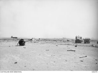 PAPUA. 1942-08-18. DAMAGED AND LITTERED RUNWAY OF SEVEN MILE AERODROME NEAR PORT MORESBY AFTER A RAID BY 24 JAPANESE BOMBERS. ONE MAN WAS KILLED AND THIRTEEN INJURED; FOUR AIRCRAFT DESTROYED AND ..