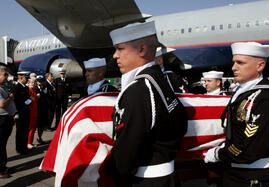 A Naval honor guard carries the casket of Ensign Robert Keller, who was killed in WWII, on the tarmac at Denver International Airport on Tuesday, June 20, 2006, upon his arrival from Hawaii. In 1942, WWII naval airman Robert Keller was killed in the Aeut