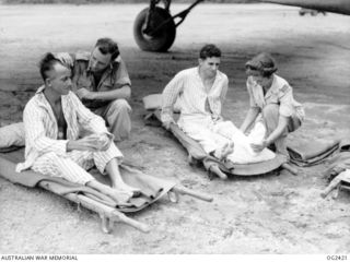TOROKINA, BOUGAINVILLE ISLAND, SOLOMON ISLANDS. 1945-04-07. SENIOR SISTER NAN KENDRICK OF MELBOURNE, VIC (RIGHT), OF THE RAAF MEDICAL AIR EVACUATION TRANSPORT UNIT, ATTENDING PATIENTS UNDER ONE ..