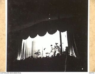 ELA BEACH, NEW GUINEA. 1943-12-21. MEMBERS OF THE GLADYS MONCRIEFF CONCERT PARTY, WHO ENTERTAINED THE TROOPS AT THE ELA BEACH SPORTS GROUND, RECEIVING BOUQUETS FROM THE AUDIENCE AT THE CONCLUSION ..