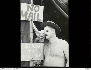 NADZAB, NEW GUINEA. C. 1944-02. NO. 24 SQUADRON RAAF WITH VULTEE VENGEANCE AIRCRAFT WAS STATIONED IN THE NADZAB AREA. "DRY YOUR EYES" IS THE RAAF WAY OF SAYING "STOP COMPLAINING". A BARE-CHESTED ..