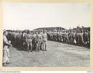 TOROKINA, BOUGAINVILLE. 1945-09-21. JAPANESE TROOPS FROM NAURU ISLAND, HAVING ARRIVED AT TOROKINA PER SS RIVER BURDEKIN, LINED UP ON THE SHORE READY FOR THE TEN MILE MARCH TO THE PRISON COMPOUND AT ..
