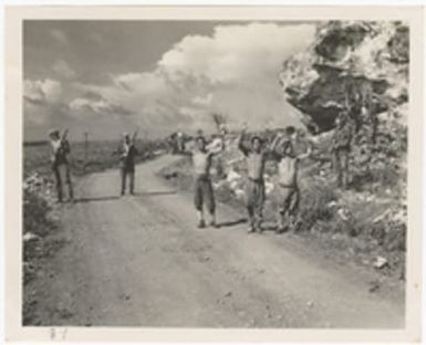 [Servicemen guarding captured Japanese men]