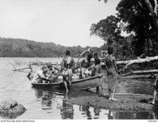 MALASIGE, NEW GUINEA, 1943-10-23. NG2260 WARRANT OFFICER II. H.R. WALES (1) OF THE AUSTRALIAN AND NEW GUINEA ADMINISTRATIVE UNIT AND CORPORAL "SCOTTY" MAIN OF THE 1ST AUSTRALIAN WATER TRANSPORT ..