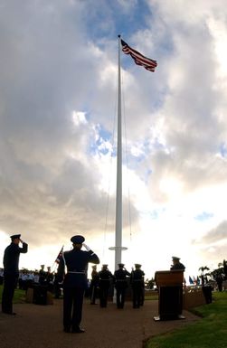 U.S. Air Force 15th Airlift Wing Commander, COL. Ray Torres (left), salutes as the flag is raised during the 63rd anniversary of the attack on Hickam Field, at Hickam Air Force Base, Hawaii, on Dec. 7, 2004. (U.S. Air Force PHOTO by Mysti Bicoy, CIV.) (Released)