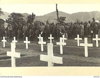 DUMPU, NEW GUINEA. 1944-02-06. TROOPS ATTENDING THE DEDICATION SERVICE AT THE DUMPU WAR CEMETERY. GRAVES OF MEN WHO FELL IN THE MARKHAM AND RAMU VALLEY CAMPAIGN ARE IN THE FOREGROUND
