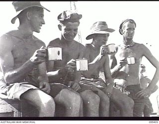 WEWAK HARBOUR, NEW GUINEA, 1945-12-13. APPROXIMATELY 2,200 MEMBERS OF 6 DIVISION EMBARKED ON THE AIRCRAFT CARRIER HMS IMPLACABLE FOR RETURN TO AUSTRALIA. SHOWN, A GROUP DRINKING TEA DURING LOADING ..