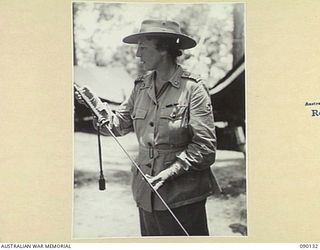 BOUGAINVILLE. 1945-03-31. LADY WAKEHURST EXAMINING A JAPANESE SWORD DURING HER VISIT, WITH LORD WAKEHURST, GOVERNOR OF NEW SOUTH WALES AND LADY BLAMEY TO THE NORTH BOUGAINVILLE AREA WHERE TROOPS OF ..