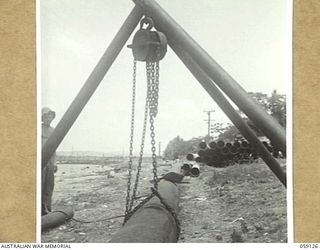 HANABADA, NEW GUINEA, 1943-10-23. NEW OIL PIPELINE UNDER CONSTRUCTION BY MEMBERS OF THE 14TH AUSTRALIAN FIELD COMPANY, ROYAL AUSTRALIAN ENGINEERS. THIS LINE WILL RUN FROM THE JETTY TO THE NEW OIL ..