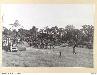 TOROKINA, BOUGAINVILLE. 1945-05-18. LIEUTENANT GENERAL S.G. SAVIGE, GENERAL OFFICER COMMANDING 2 CORPS (3), TAKING THE SALUTE DURING THE MARCH PAST OF TROOPS OF 7 INFANTRY BRIGADE AT GLOUCESTER ..